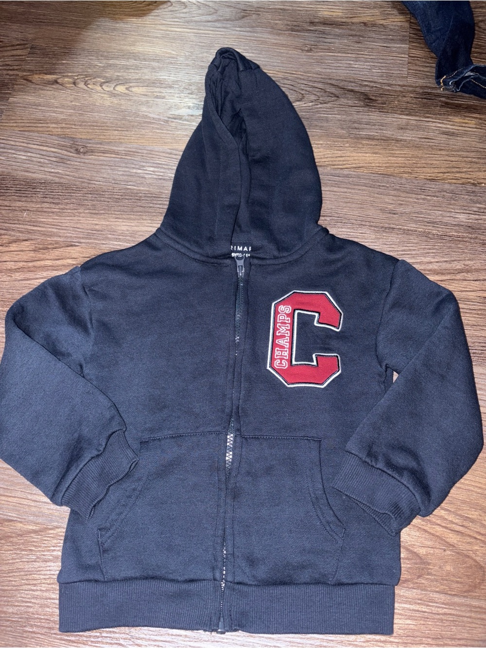 Primark Kids Boys Black Zip-Up Hoodie with Red 'C' Patch, size 4-5 yrs old